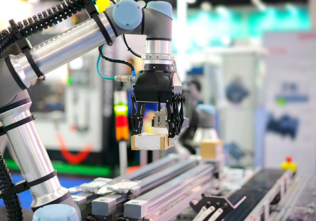 Factory 4.0 concept : View of Gripper on universal robot is picking paper box